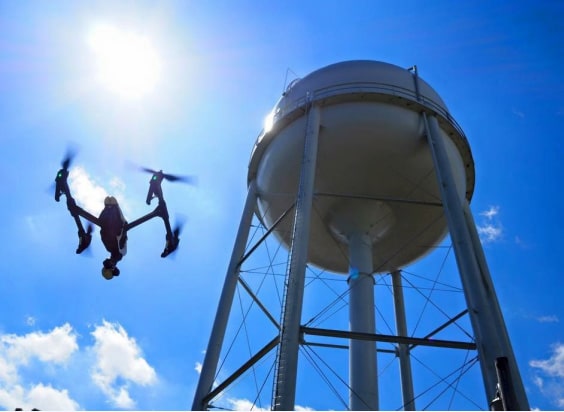 A drone flying around a water tank.