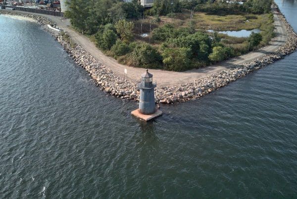 A lighthouse on the shore of a body of water.